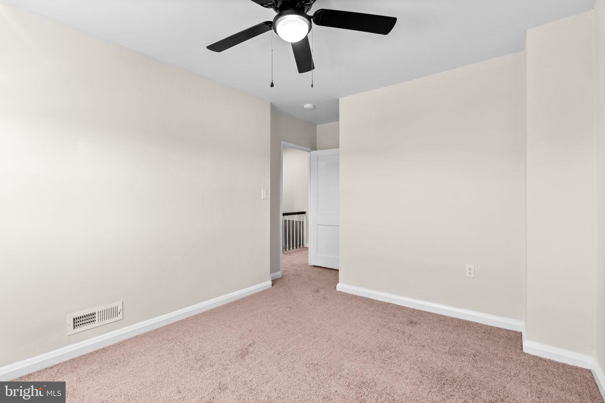 2735 Moorgate Road Dundalk, MD 21222 - Photo 19 of 35 an empty room with a ceiling fan and a window