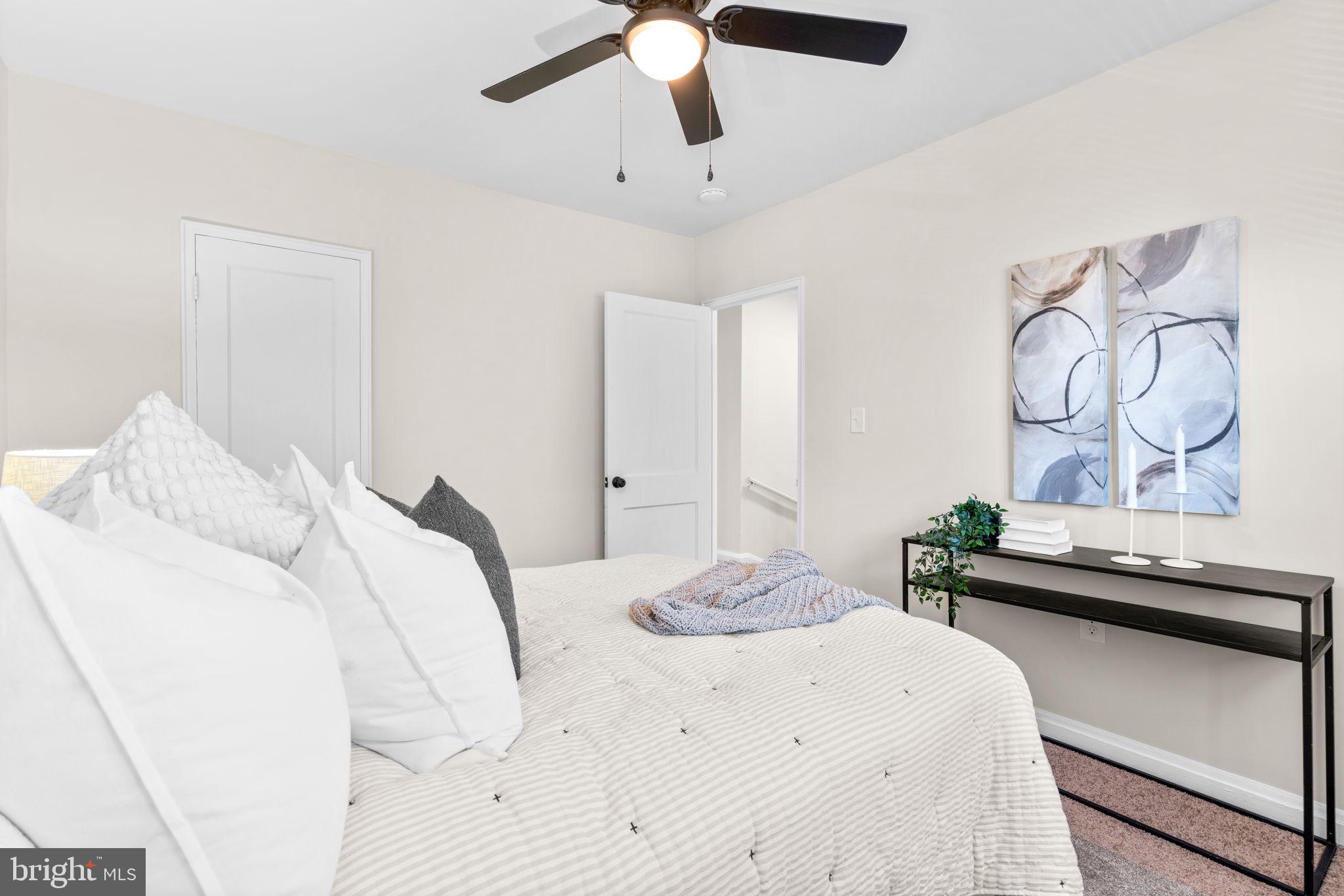 2735 Moorgate Road Dundalk, MD 21222 - Photo 21 of 35 a bedroom with a bed and a chandelier