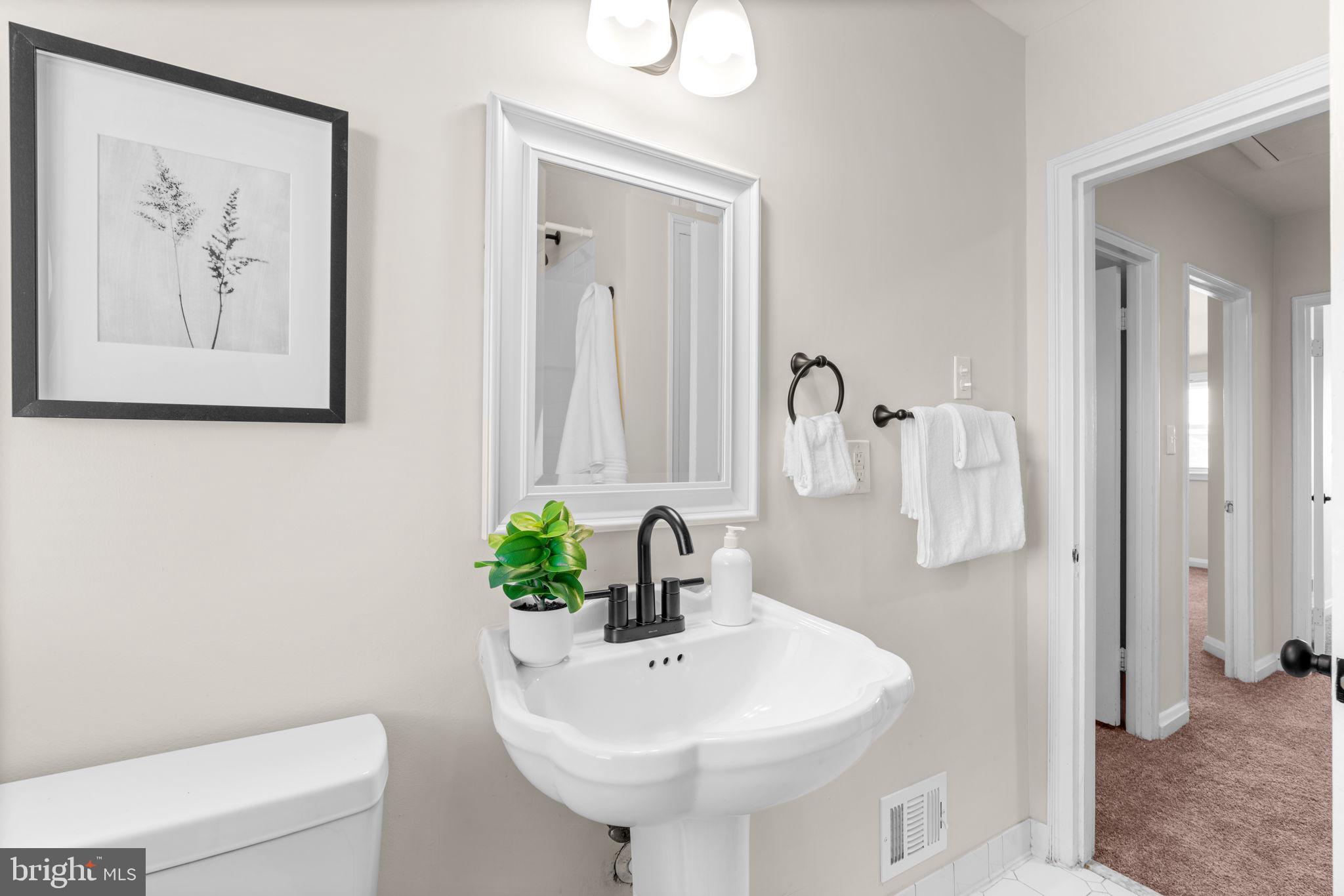 2735 Moorgate Road Dundalk, MD 21222 - Photo 22 of 35 a bathroom with a sink and a mirror