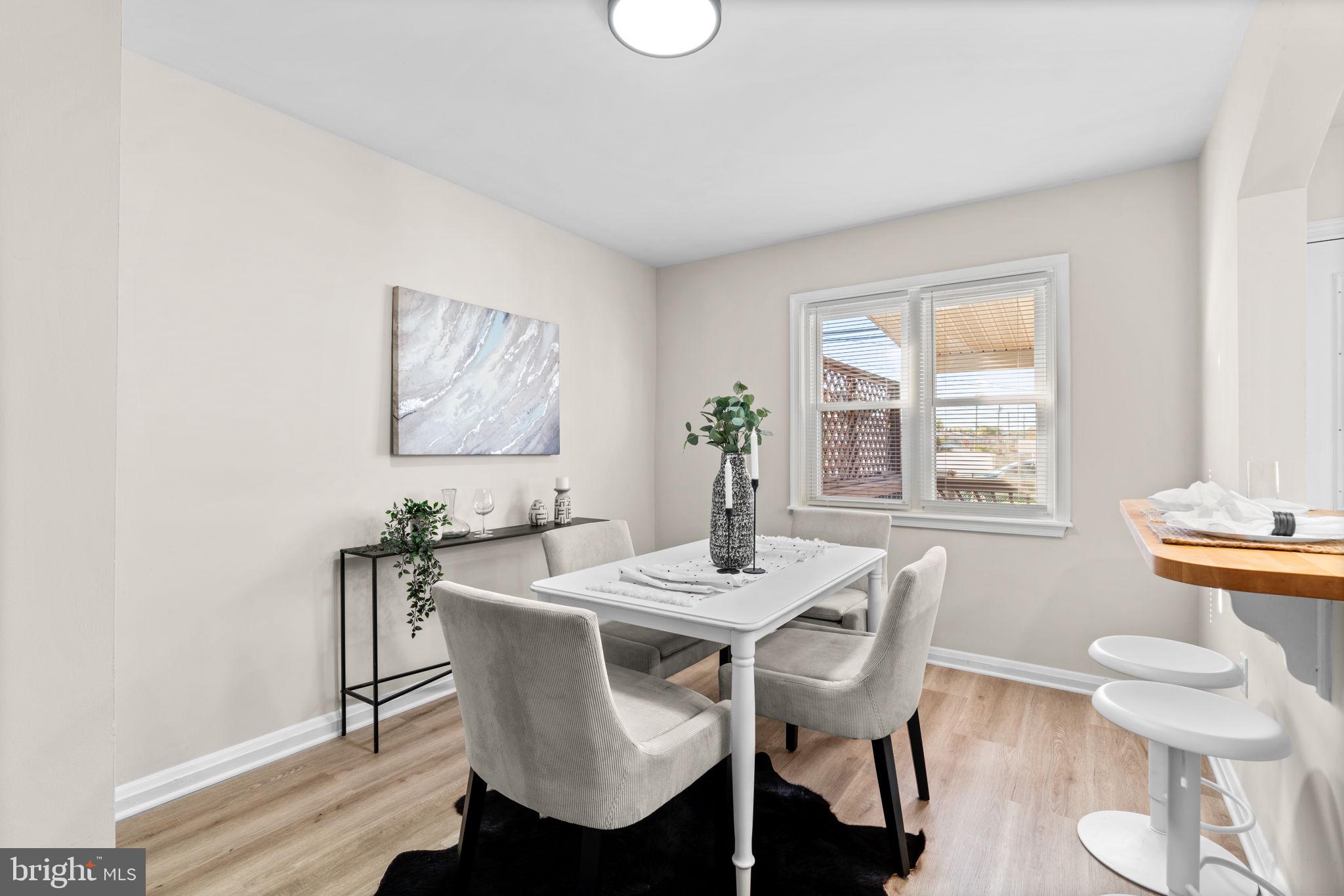 2735 Moorgate Road Dundalk, MD 21222 - Photo 8 of 35 a dining room with furniture a rug and wooden floor
