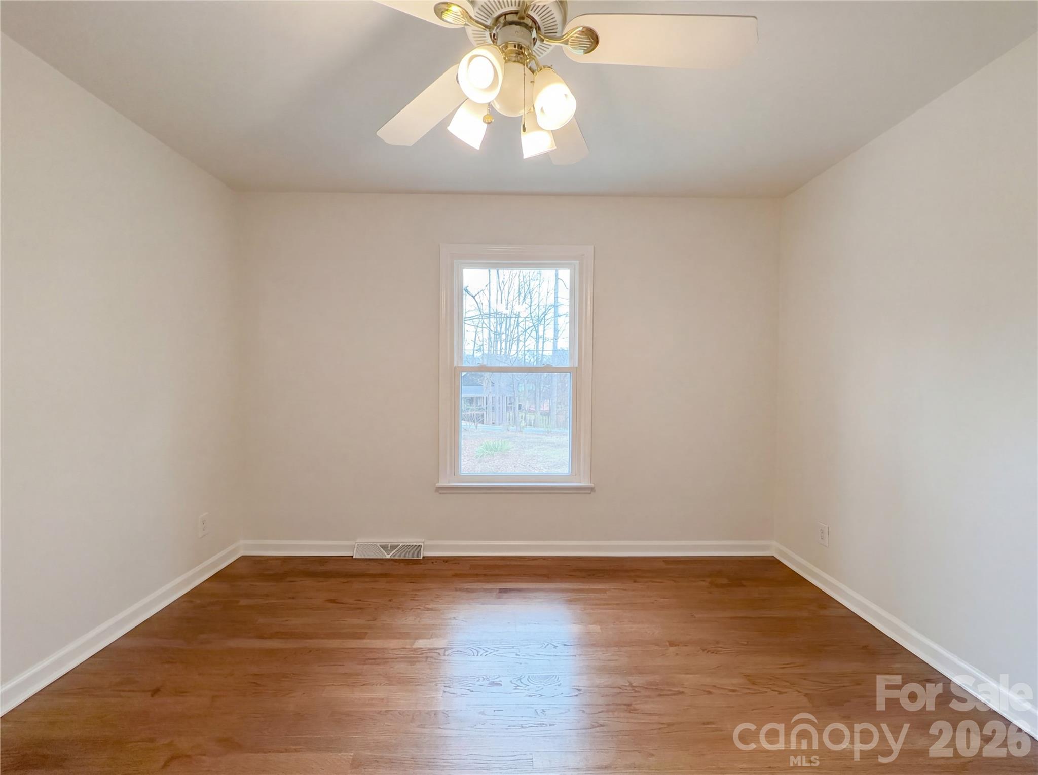 3695 Lake Shore Road South Denver, NC 28037 - Photo 11 of 16 an empty room with wooden floor and windows