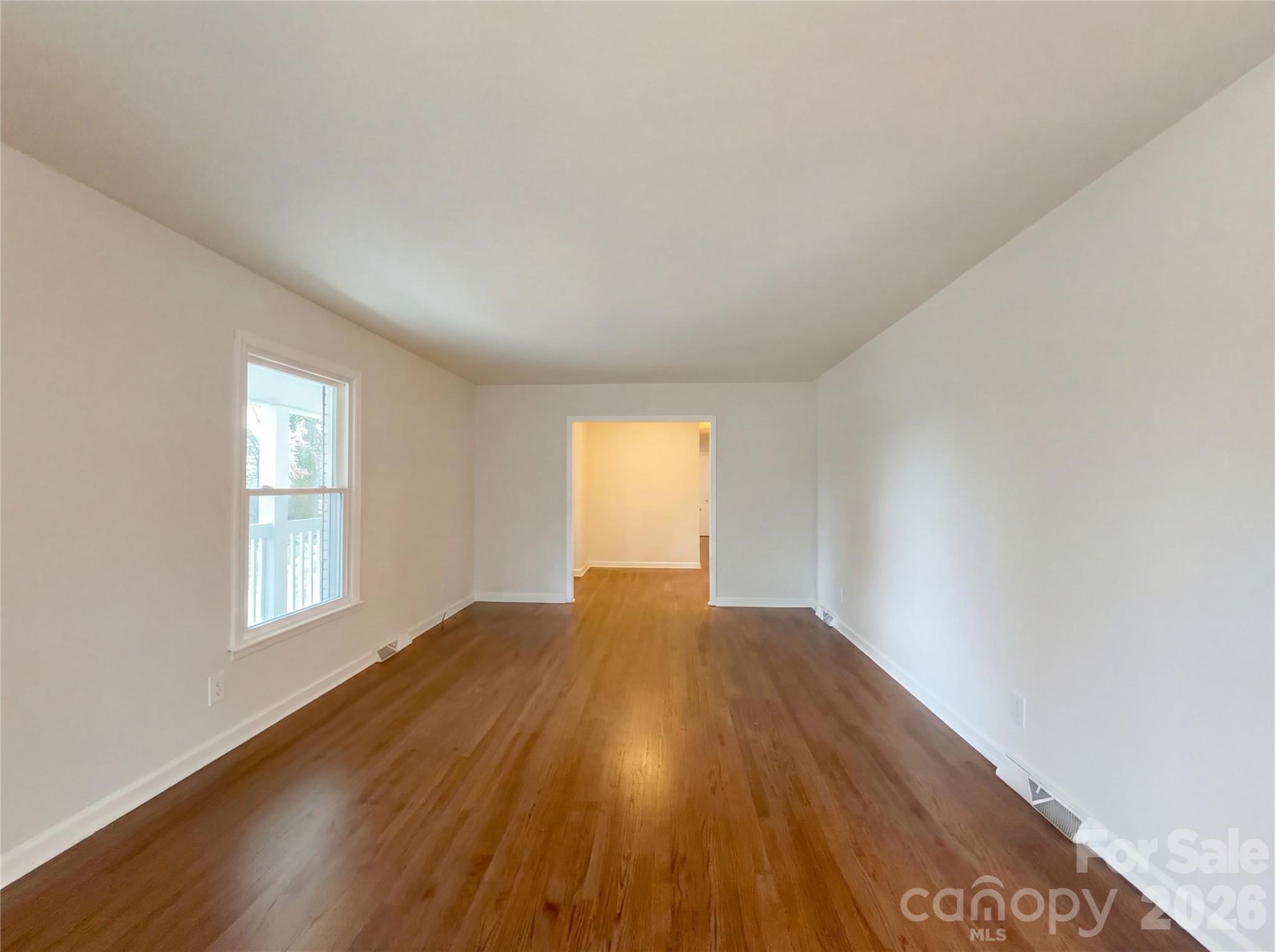 3695 Lake Shore Road South Denver, NC 28037 - Photo 12 of 16 an empty room with wooden floor and windows