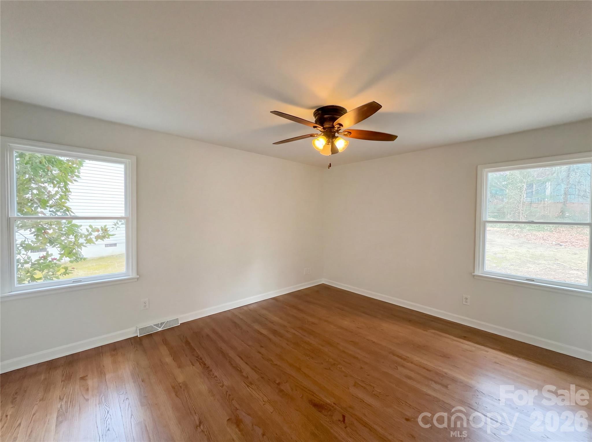 3695 Lake Shore Road South Denver, NC 28037 - Photo 14 of 16 a view of an empty room with wooden floor and a window