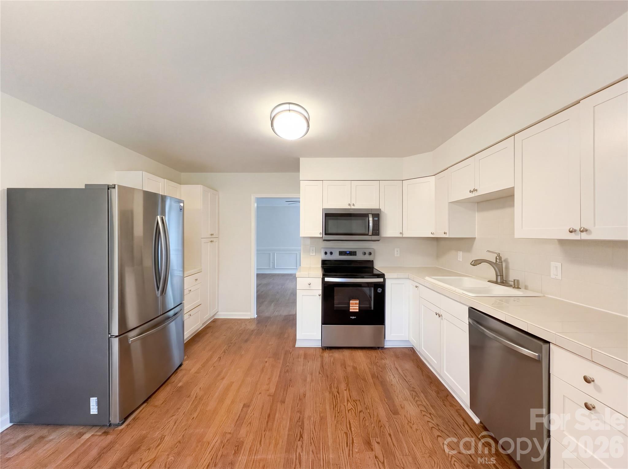 3695 Lake Shore Road South Denver, NC 28037 - Photo 2 of 16 a kitchen with stainless steel appliances a refrigerator sink and microwave