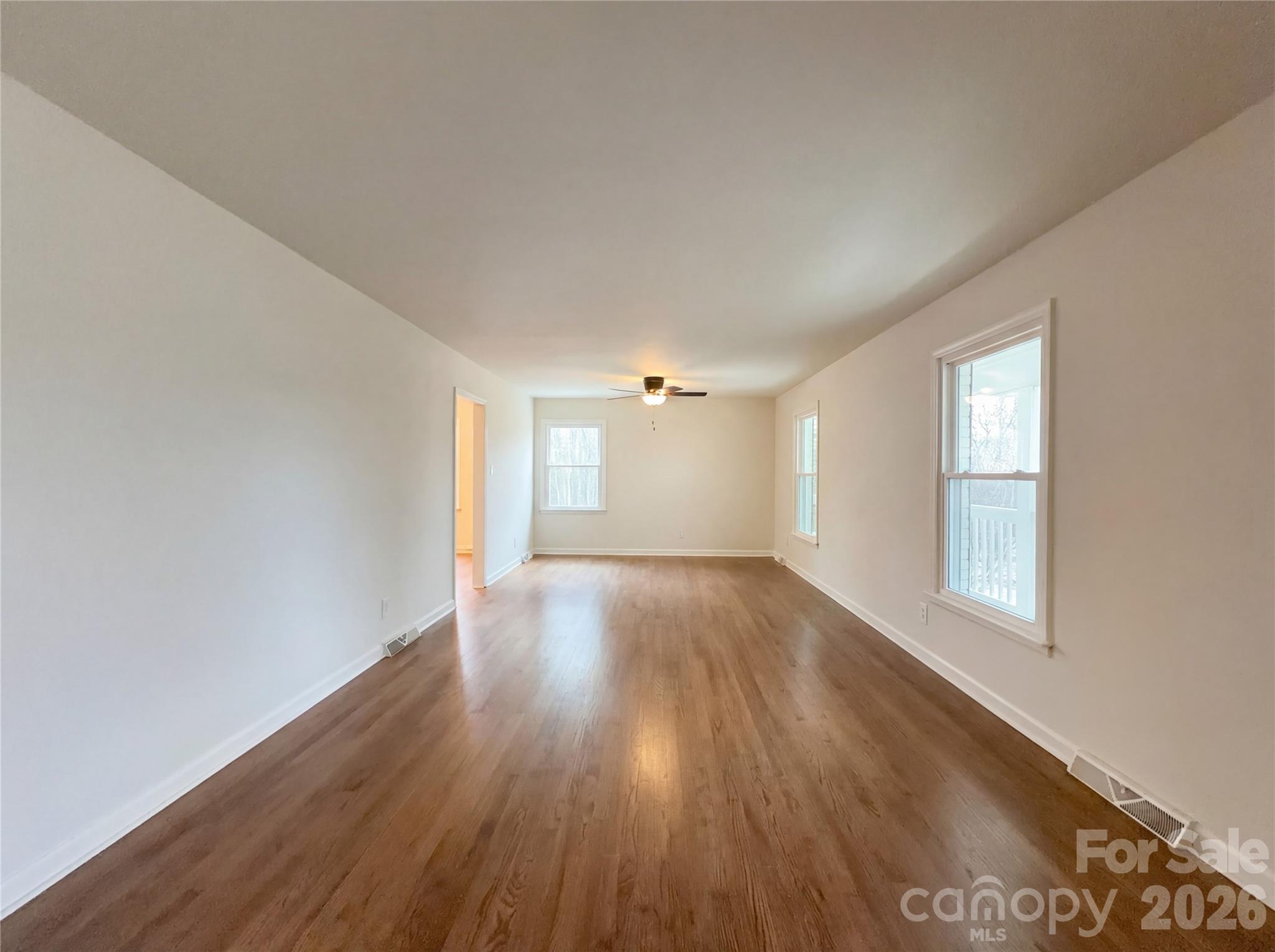 3695 Lake Shore Road South Denver, NC 28037 - Photo 3 of 16 an empty room with wooden floor and windows