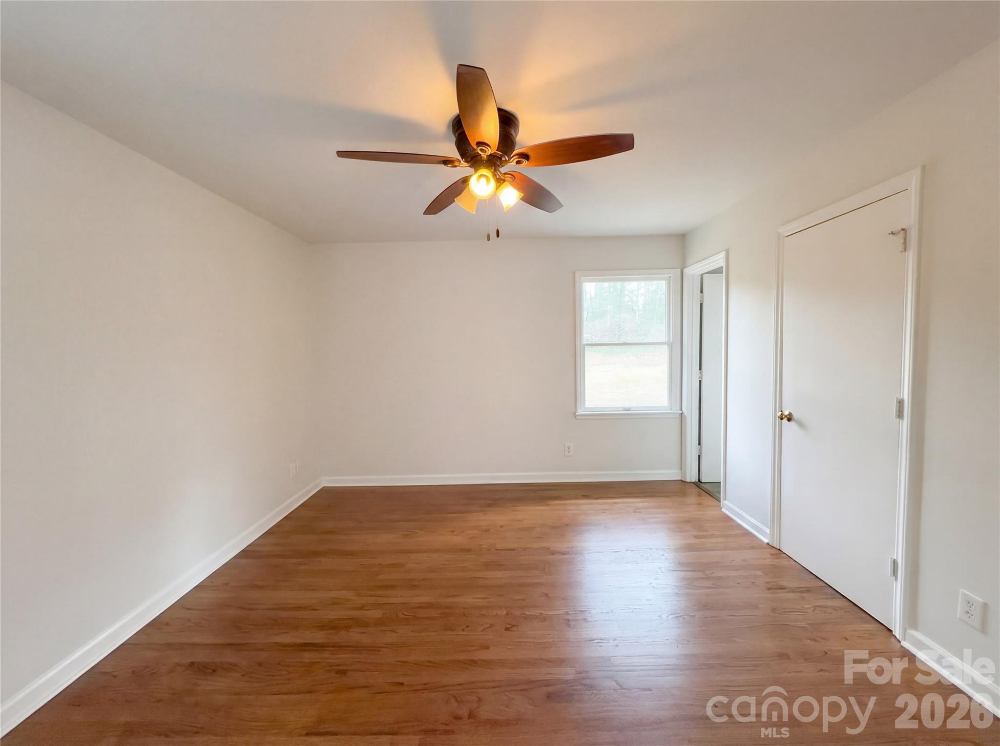 3695 Lake Shore Road South Denver, NC 28037 - Photo 4 of 16 a view of an empty room and window and chandelier fan