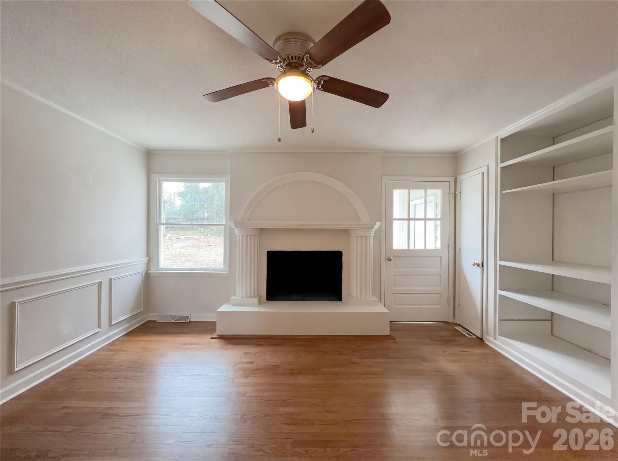 3695 Lake Shore Road South Denver, NC 28037 - Photo 8 of 16 an empty room with windows and a fireplace