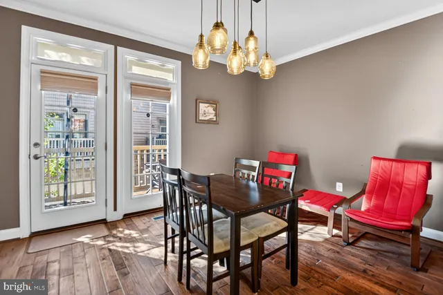 a view of a dining room with furniture and chandelier