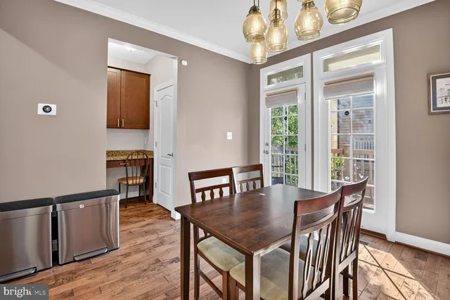 a view of a dining room with furniture and a window