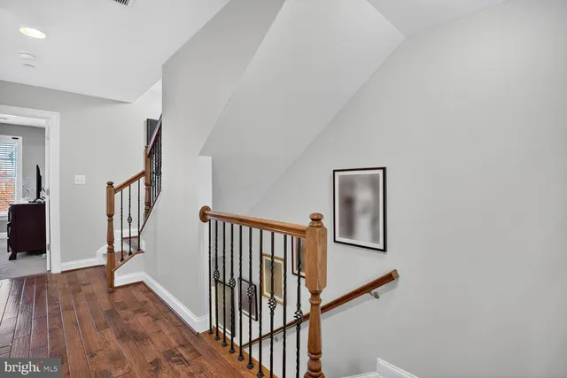 a view of staircase with wooden floor and a window