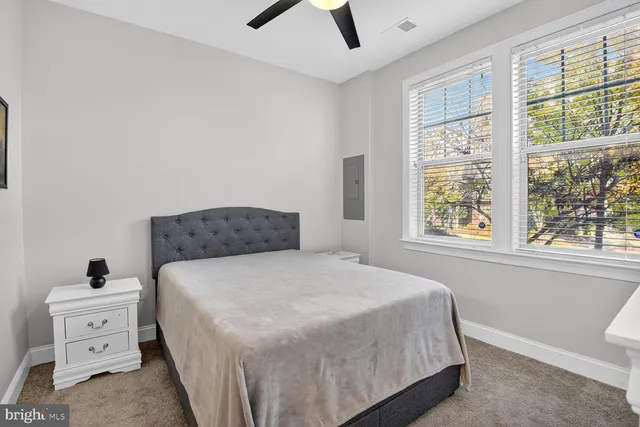 a bedroom with a bed and a window