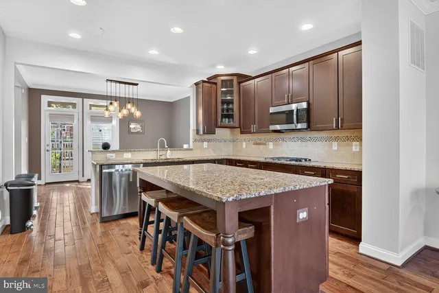 an open kitchen with a table and chairs in it