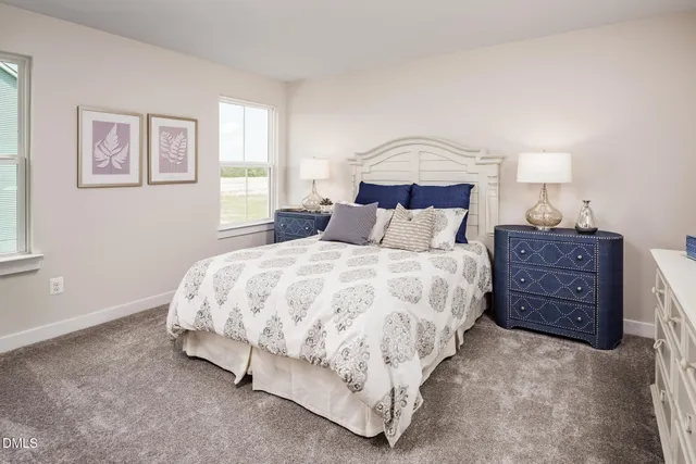 a bedroom with a bed a lamp and a window