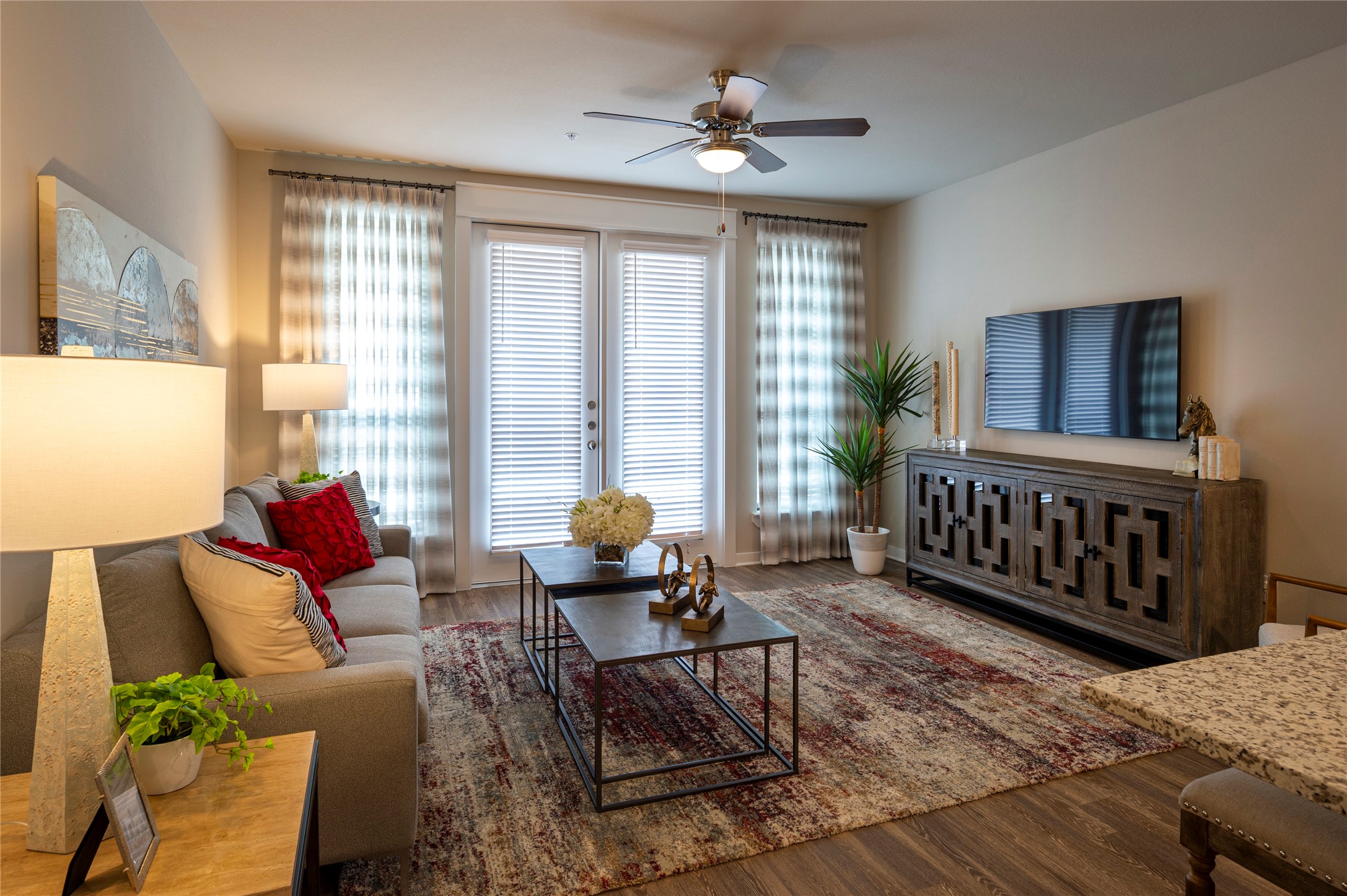 1616 Partnership Way, Unit 1220 Katy, TX 77449 - Photo 10 of 21 a living room with furniture a flat screen tv and a window
