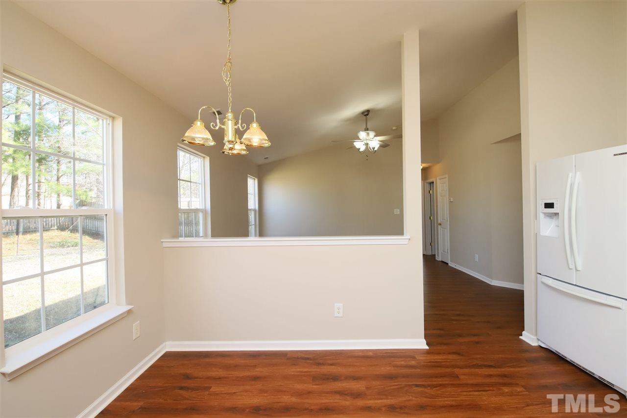 3609 Watkins Ridge Court Raleigh, NC 27616 - Photo 11 of 27 a view of a room with wooden floor and large windows