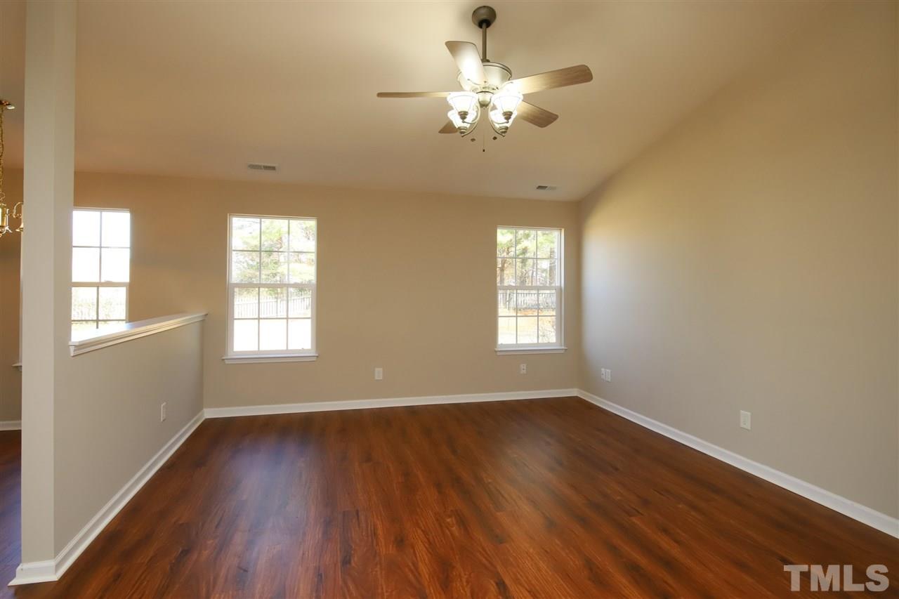 3609 Watkins Ridge Court Raleigh, NC 27616 - Photo 5 of 27 an empty room with wooden floor and windows