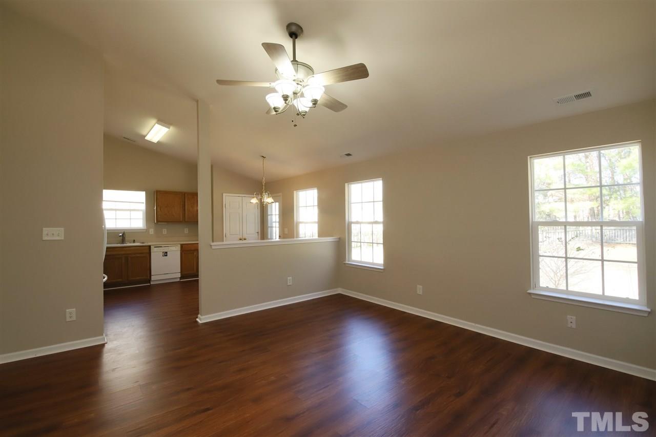 3609 Watkins Ridge Court Raleigh, NC 27616 - Photo 6 of 27 a view of a room with wooden floor and chandelier