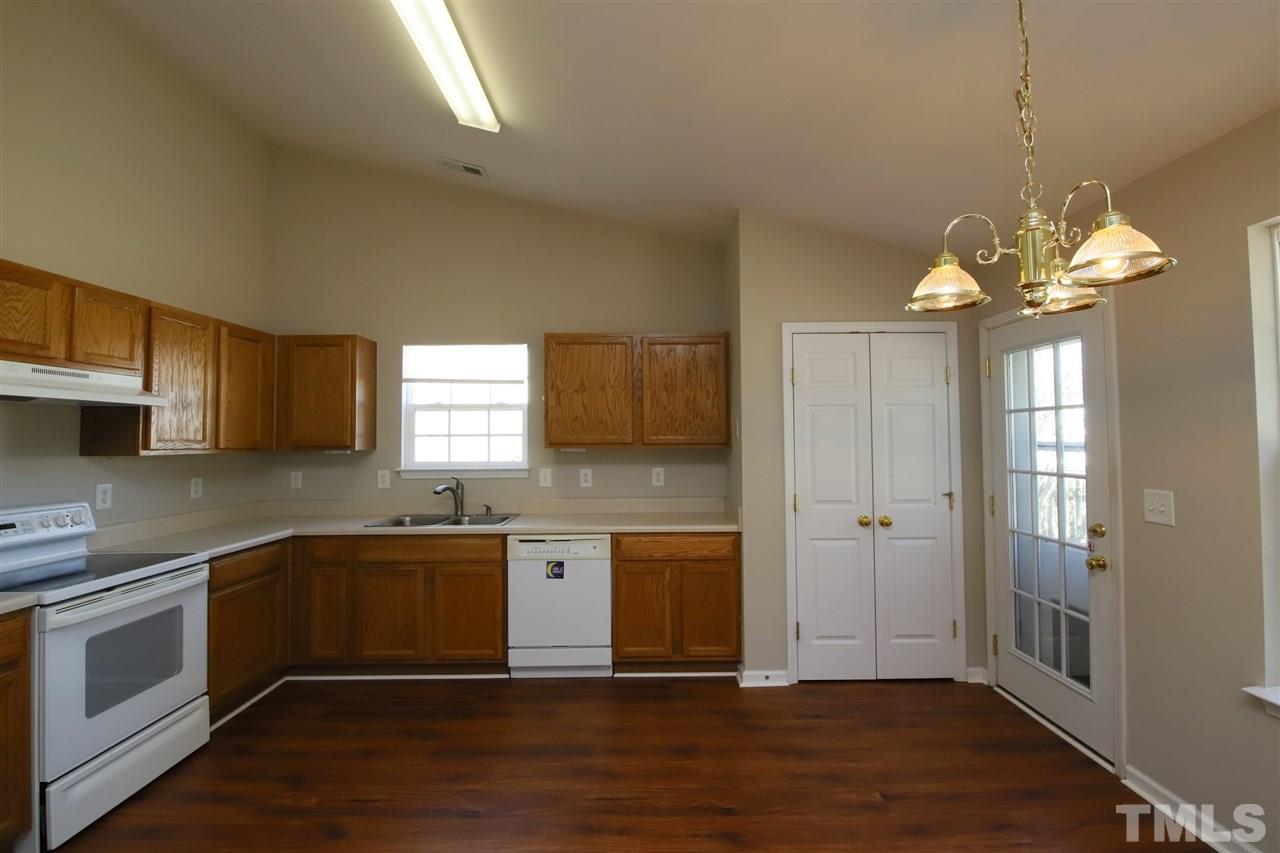 3609 Watkins Ridge Court Raleigh, NC 27616 - Photo 9 of 27 a kitchen with stainless steel appliances granite countertop a sink cabinets and wooden floor