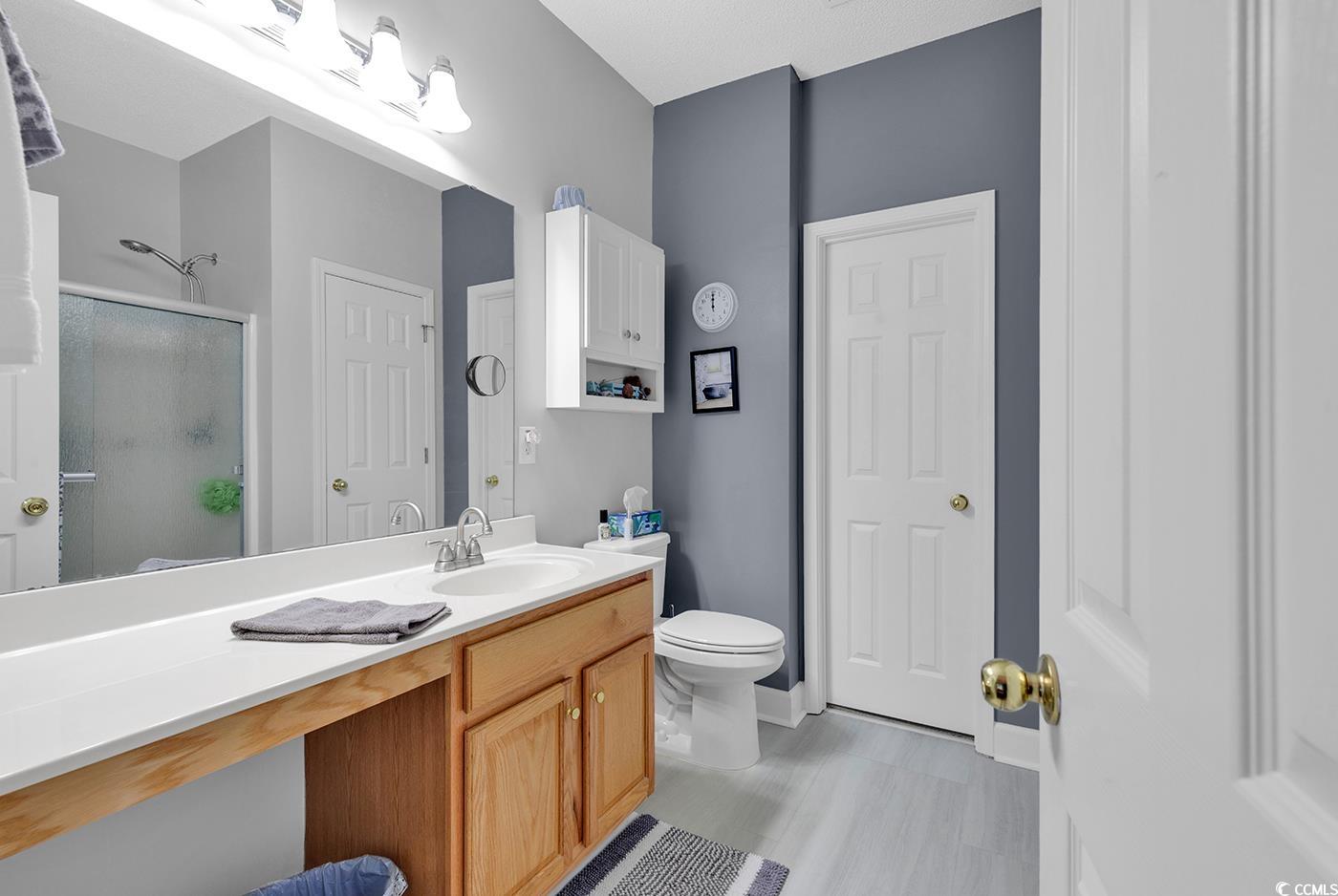 112 Coldstream Cove Loop, Unit 303 Murrells Inlet, SC 29576 - Photo 14 of 39 Bathroom featuring vanity, toilet, and an enclosed
