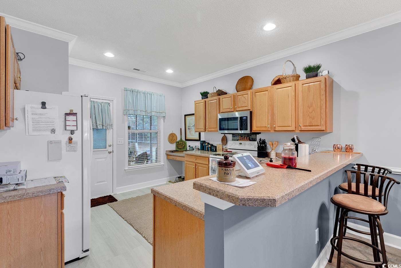112 Coldstream Cove Loop, Unit 303 Murrells Inlet, SC 29576 - Photo 2 of 39 Kitchen with light wood-type flooring, crown moldi
