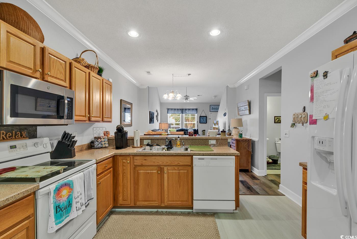 112 Coldstream Cove Loop, Unit 303 Murrells Inlet, SC 29576 - Photo 3 of 39 Kitchen featuring a notable chandelier, white appl