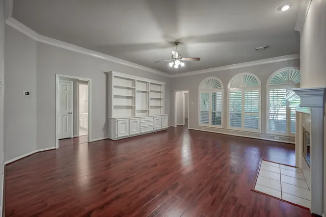 a view of a room with wooden floors swimming pool and windows