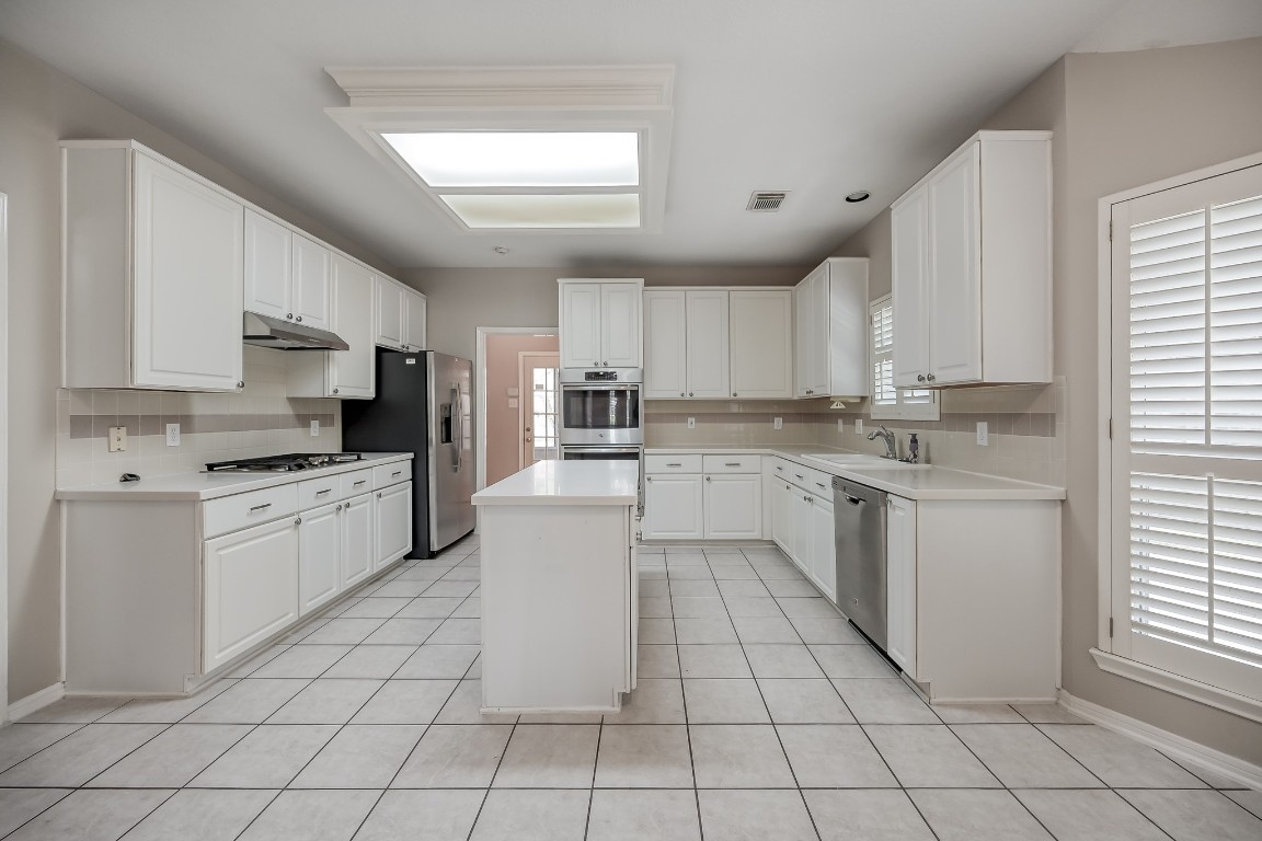 3510 Ash Glen Drive Spring, TX 77388 - Photo 17 of 39 a kitchen with a stove a sink dishwasher a refrigerator and cabinets
