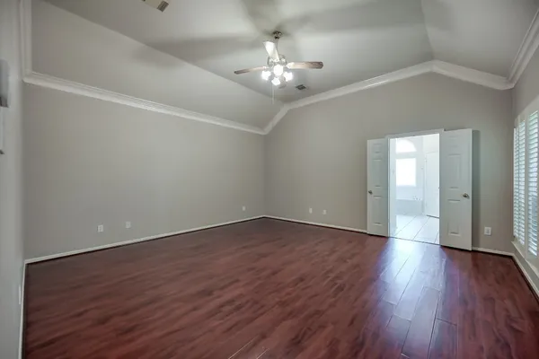 a view of an empty room with wooden floor