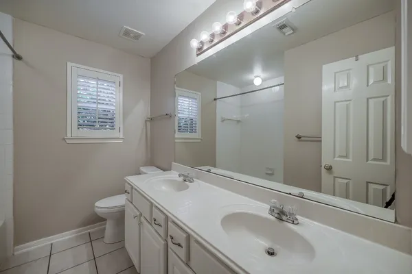a bathroom with a sink double vanity and a toilet