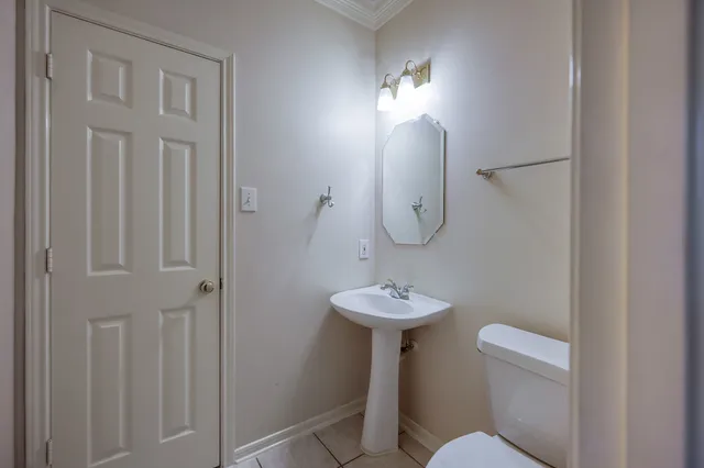 a bathroom with a toilet a sink and mirror