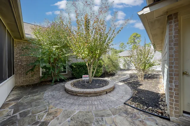 a view of a backyard with table and chairs potted plants
