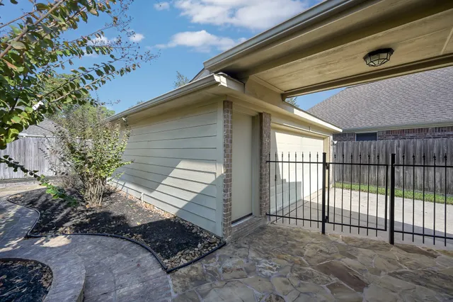 a view of a backyard with wooden fence