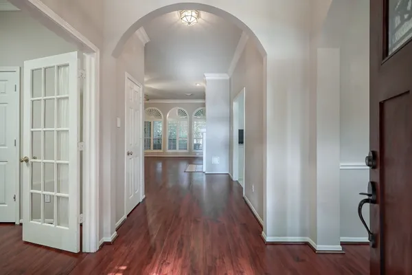 a view of a hallway with wooden floor