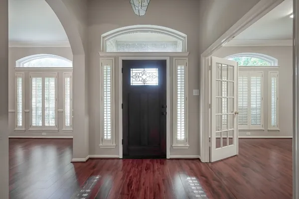 wooden floor in a hall with a window