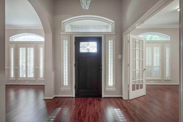 wooden floor in a hall with a window