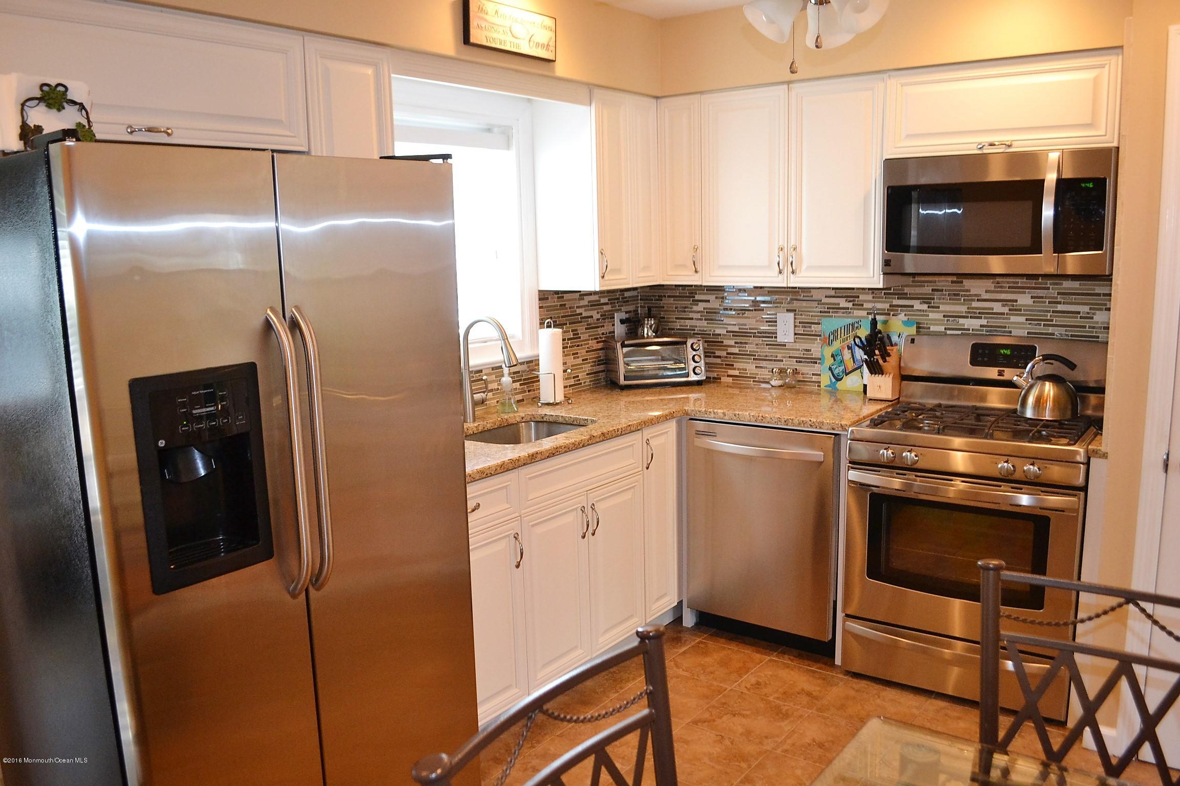 2214 Wilson Road Point Pleasant, NJ 08742 - Photo 5 of 16 a kitchen with a refrigerator stove and microwave