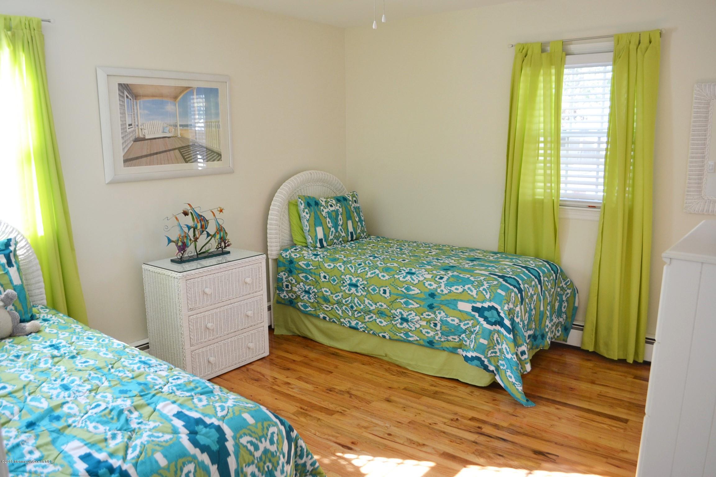 2214 Wilson Road Point Pleasant, NJ 08742 - Photo 8 of 16 a bedroom with a bed and a dresser