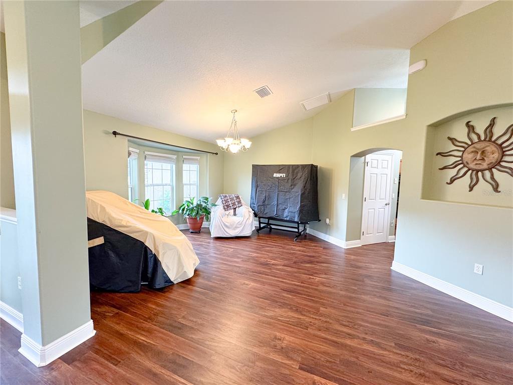 6282 Northeast 61st Ave Road Silver Springs, FL 34488 - Photo 12 of 73 a living room with furniture and a wooden floor