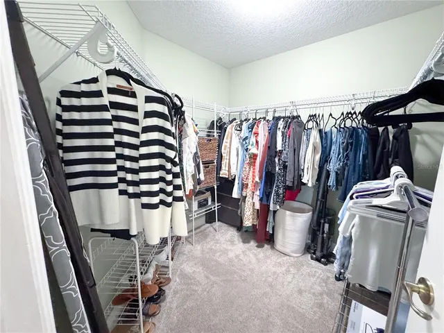 a large kitchen with stainless steel appliances granite countertop a stove a sink dishwasher a dining table and chair with wooden floor