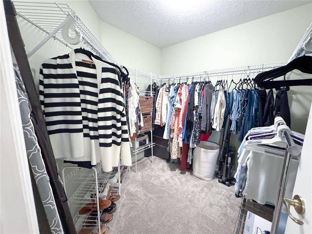 6282 Northeast 61st Ave Road Silver Springs, FL 34488 - Photo 17 of 73 a view of walk in closet with clothes and shoes