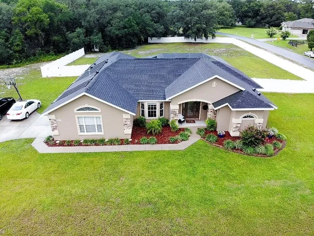 a aerial view of a house with swimming pool and big yard