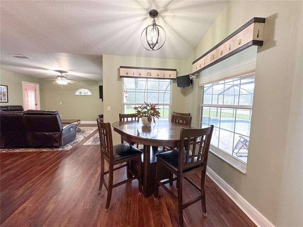 6282 Northeast 61st Ave Road Silver Springs, FL 34488 - Photo 26 of 73 a view of a dining room with furniture window and wooden floor