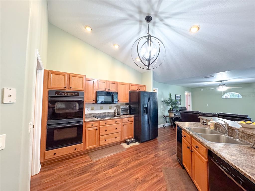 6282 Northeast 61st Ave Road Silver Springs, FL 34488 - Photo 29 of 73 a kitchen with stainless steel appliances granite countertop a kitchen island a stove and a sink