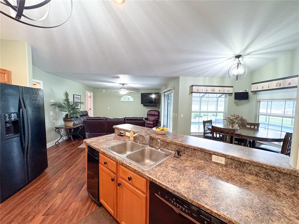 6282 Northeast 61st Ave Road Silver Springs, FL 34488 - Photo 30 of 73 a kitchen with stainless steel appliances granite countertop a sink a stove and a refrigerator