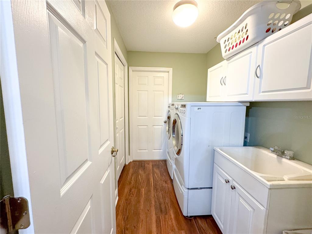 6282 Northeast 61st Ave Road Silver Springs, FL 34488 - Photo 32 of 73 a view of walk in closet with window and wooden floor