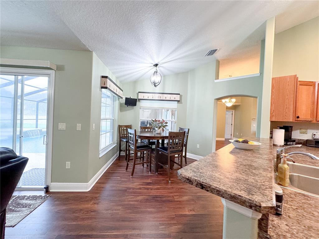6282 Northeast 61st Ave Road Silver Springs, FL 34488 - Photo 42 of 73 a view of a a dining room with furniture window and wooden floor