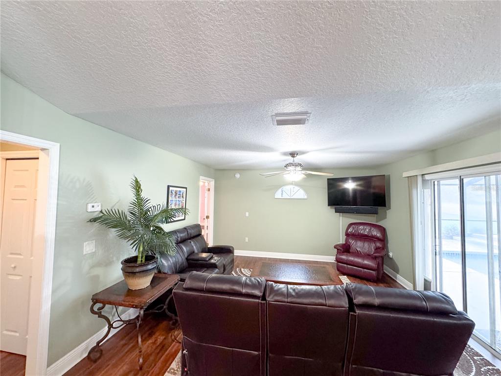 6282 Northeast 61st Ave Road Silver Springs, FL 34488 - Photo 47 of 73 a living room with furniture and a flat screen tv