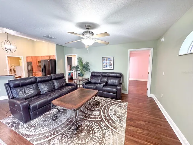 a view of a green field with wooden fence