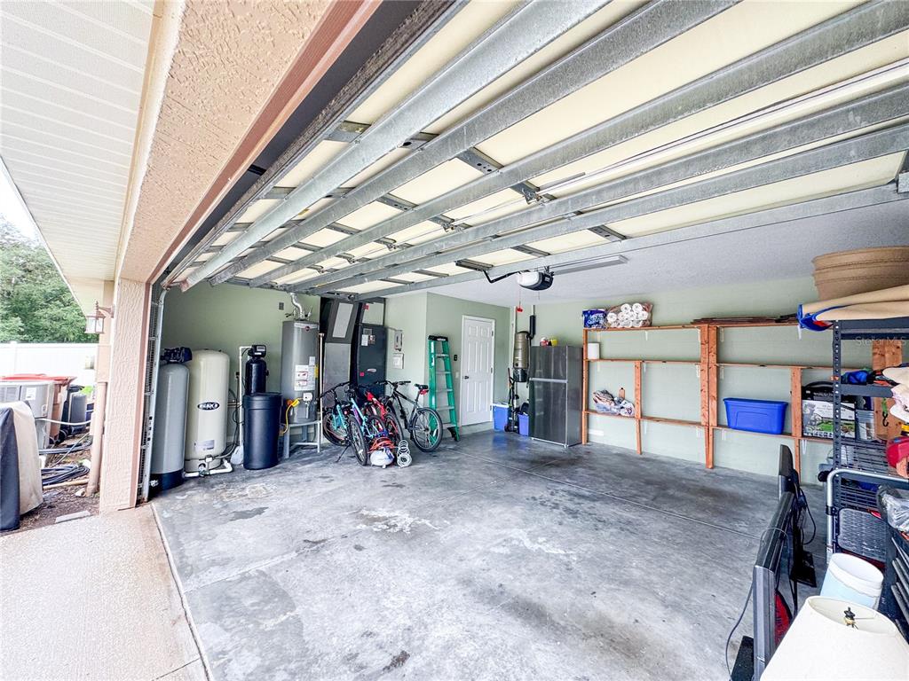 6282 Northeast 61st Ave Road Silver Springs, FL 34488 - Photo 72 of 73 a view of a garage with an bike and car