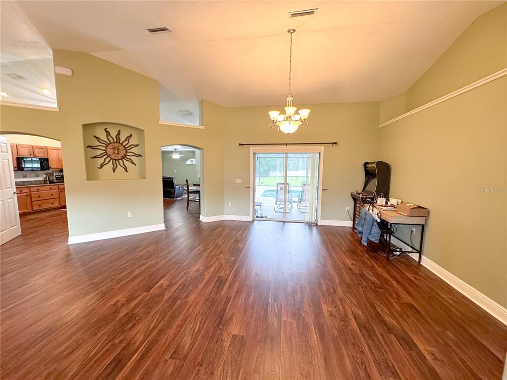 6282 Northeast 61st Ave Road Silver Springs, FL 34488 - Photo 10 of 73 a view of a livingroom with furniture wooden floor front door and a window